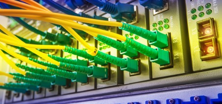 Fiber Optic cables connected to an optic ports and Network cables connected to ethernet ports